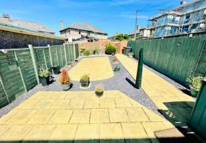 een patio met potplanten en een hek bij Lovely and affordable house closer to the sea in Hartlepool