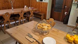 uma mesa de madeira com uma tigela de comida em cima em B&B Casa Zeni em Faedo