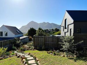 a church and a yard with a fence and a house at Stylish Garden Retreat in Cape Town