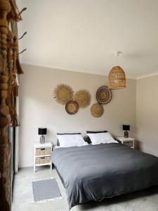 a bedroom with a large bed and two night stands at Stylish Garden Retreat in Cape Town