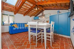 a kitchen and living room with a table and chairs at Apartments Casa Rubeus Rovinj in Rovinj +3 photos