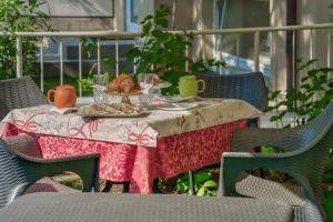 a table with a plate of food on it at Villa Liberty in Boario Terme +21 photos