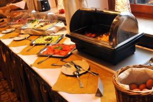 a buffet line with food on a table at Hotel Niedersfeld-Winterberg in Winterberg