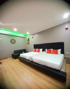a bedroom with a large bed with red pillows at Sawasdee​ Buriram​ Resort in Buriram