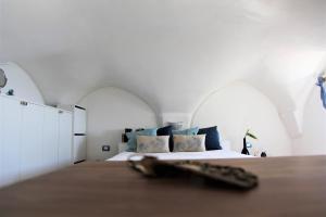 a bedroom with a large bed with two arched windows at Il Fiordo in Conca dei Marini