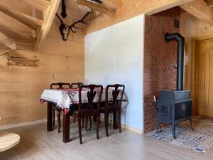 伊圖芙的住宿－Domek góralski Cudna izba，一间带桌子和燃木炉的用餐室