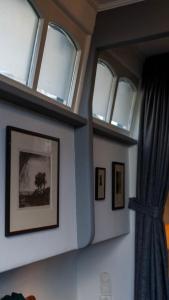 a room with three windows on the wall at Amsterdam Center - Houseboat B&B by Captain Ricard in Amsterdam
