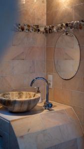 a sink in a bathroom with a mirror at Amsterdam Center - Houseboat B&B by Captain Ricard in Amsterdam