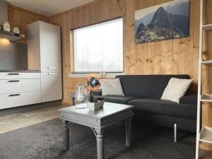a living room with a couch and a table at Sunny view Egmond in Egmond-Binnen
