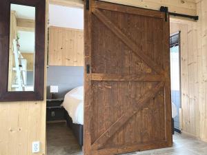 a sliding barn door in a bedroom with a bed at Sunny view Egmond in Egmond-Binnen