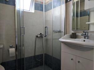 a bathroom with a shower and a sink at Vikentios Rooms in Kythira
