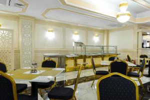 a restaurant with tables and chairs in a room at Little Orient in Brăila
