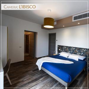 a bedroom with a blue bed in a room at Casale Ermo Colle in San Filippo