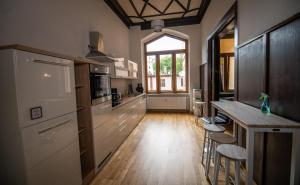 a kitchen with a counter and some stools in it at tRAUMhaus in Erfurt
