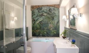 a bathroom with a painting on the wall at Residenza le Colline del Paradiso in Bivigliano