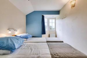 a bedroom with two beds with blue walls and a window at Residence Port Bourgenay - maeva Home in Talmont +81 photos