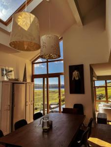 a dining room with a table and views of the ocean at Barleycove Villa, Goleen, West Cork in Goleen
