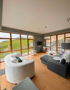 a large living room with two couches and a couch at Barleycove Villa, Goleen, West Cork in Goleen