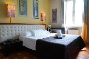 a bedroom with a large bed in a room at Roma Room Hotel in Rome