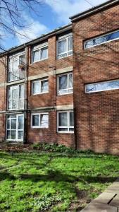 a brick building with windows on the side of it at Two bedroom flat in London near the 02 in London