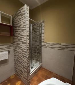 a bathroom with a shower with a glass door at Roma Room Hotel in Rome