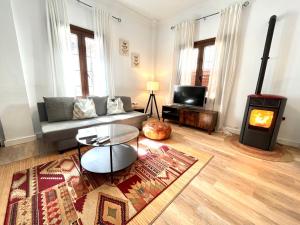 a living room with a couch and a wood stove at Apartamento centro historico in Ronda