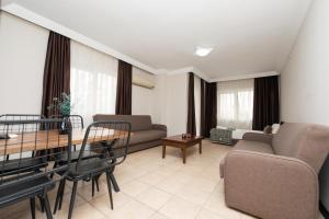 a living room with a couch and a table at City Inn Family Apart in Antalya