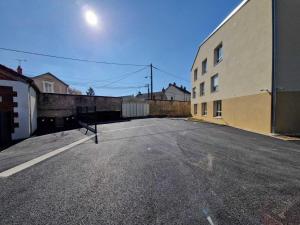 an empty parking lot next to a building at Résidence La Pyro in Bourges