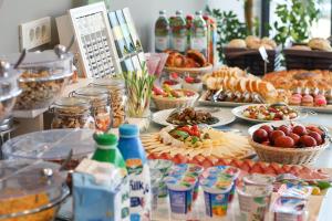 a buffet of food on a table with plates of food at Pansion Leggero in Krk