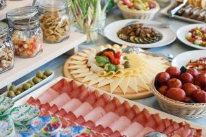 a table with plates of food and bowls of fruit at Pansion Leggero in Krk
