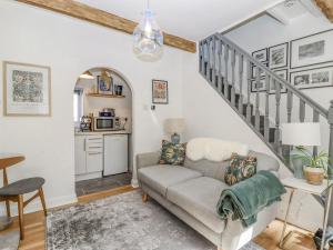 a living room with a couch and a staircase at 4 Pulmans Place in Halifax