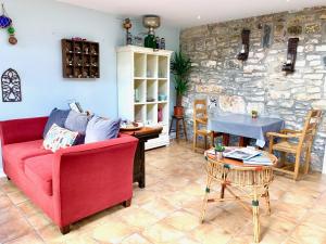 a living room with a red couch and a table at Riverside House in Newport