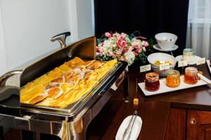 a table with a tray of food on a stove at Hotel Wyspiański in Krakow