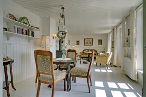亨能史特蘭德的住宿－Det Gamle Badehotel - Klitgaarden，一间带桌椅的用餐室