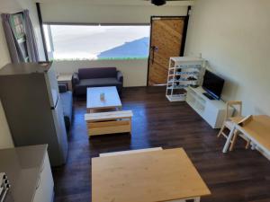a living room with a couch and a table at 梅園小築民宿 in Chishang