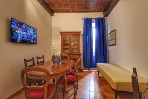 uma sala de estar com uma mesa e uma cama em Biscione Large Apartment - Campo de Fiori by YourHost em Roma