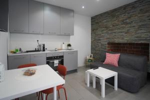 a kitchen and living room with a couch and a table at Apartments Choice in Velika Gorica