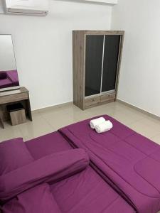 a room with a purple blanket on the floor at 92D’venus Residence in Sitiawan