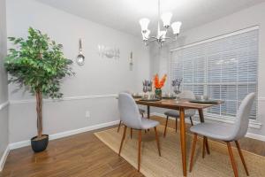 uma sala de jantar com uma mesa e cadeiras e um vaso de plantas em IDYLLIC LAKEVIEW HOME em Spring