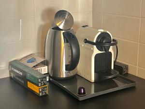 a counter top with a coffee maker and a tea kettle at Studio Mila in Kranjska Gora +6 photos