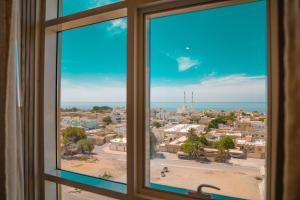 een raam met uitzicht op de stad bij M14 Hotel Apartment in Ras al Khaimah