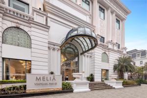 a store front of a building with a sign in front at Meliá Vinpearl Phu Ly in Phủ Lý