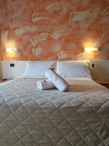 a bedroom with a large bed with two pillows at Hotel La Rocca in San Marino