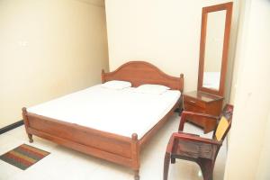 Ένα ή περισσότερα κρεβάτια σε δωμάτιο στο Hotel Prasanna