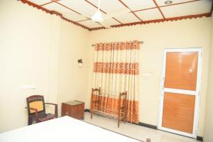 Ένα ή περισσότερα κρεβάτια σε δωμάτιο στο Hotel Prasanna