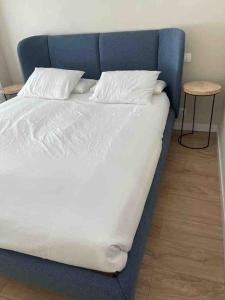 1 cama grande con cabecero azul y mesa en Piso de lujo en centro de valladolid, en Valladolid
