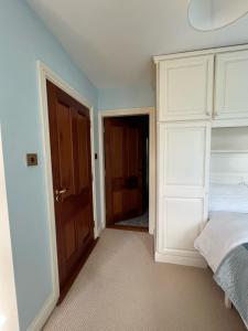 a bedroom with a bed and a door to a hallway at Taylors Hill Luxury Guest House in Galway