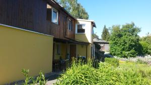 una casa amarilla con una valla al lado en Harzhexe1, en Güntersberge