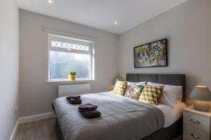 a bedroom with a bed with pillows and a window at Altham Place-Free Parking Space in Morecambe