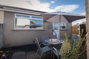 a table with an umbrella on a patio at Altham Place-Free Parking Space in Morecambe